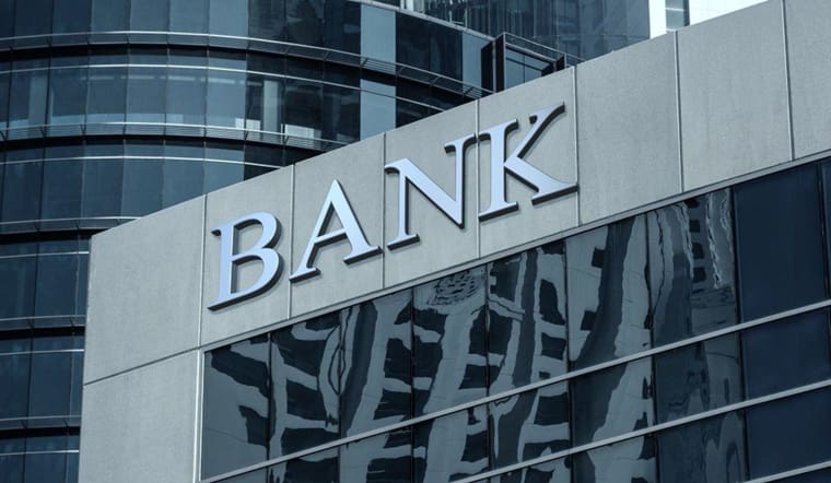 A bank sign on the side of a building.