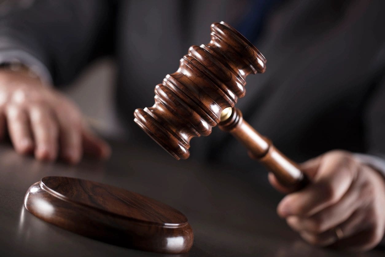 A person holding a gavel in their hand.