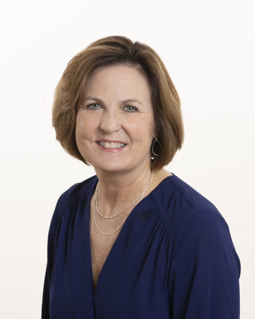 Portrait of a smiling middle-aged woman with short brown hair.